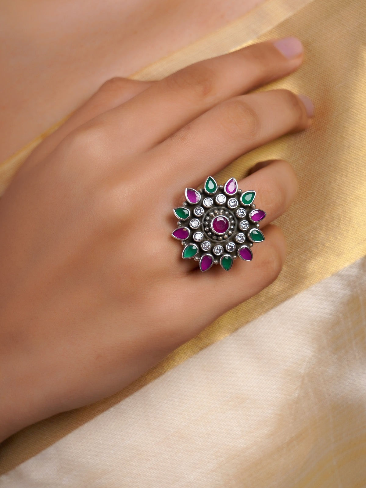 Samragni oxidized kundan floral statement ring with ruby-pink and emerald-green teardrop stones, white accents and silver-tone finish