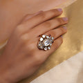 Sitaratna white moissanite artisan cluster statement ring with large clear centre stone, mixed-cut white stones and subtle ruby-pink accents