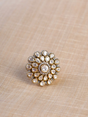 Sitaratna white moissanite floral halo statement ring shown on hand with layered pear-shaped white stones around a round centre