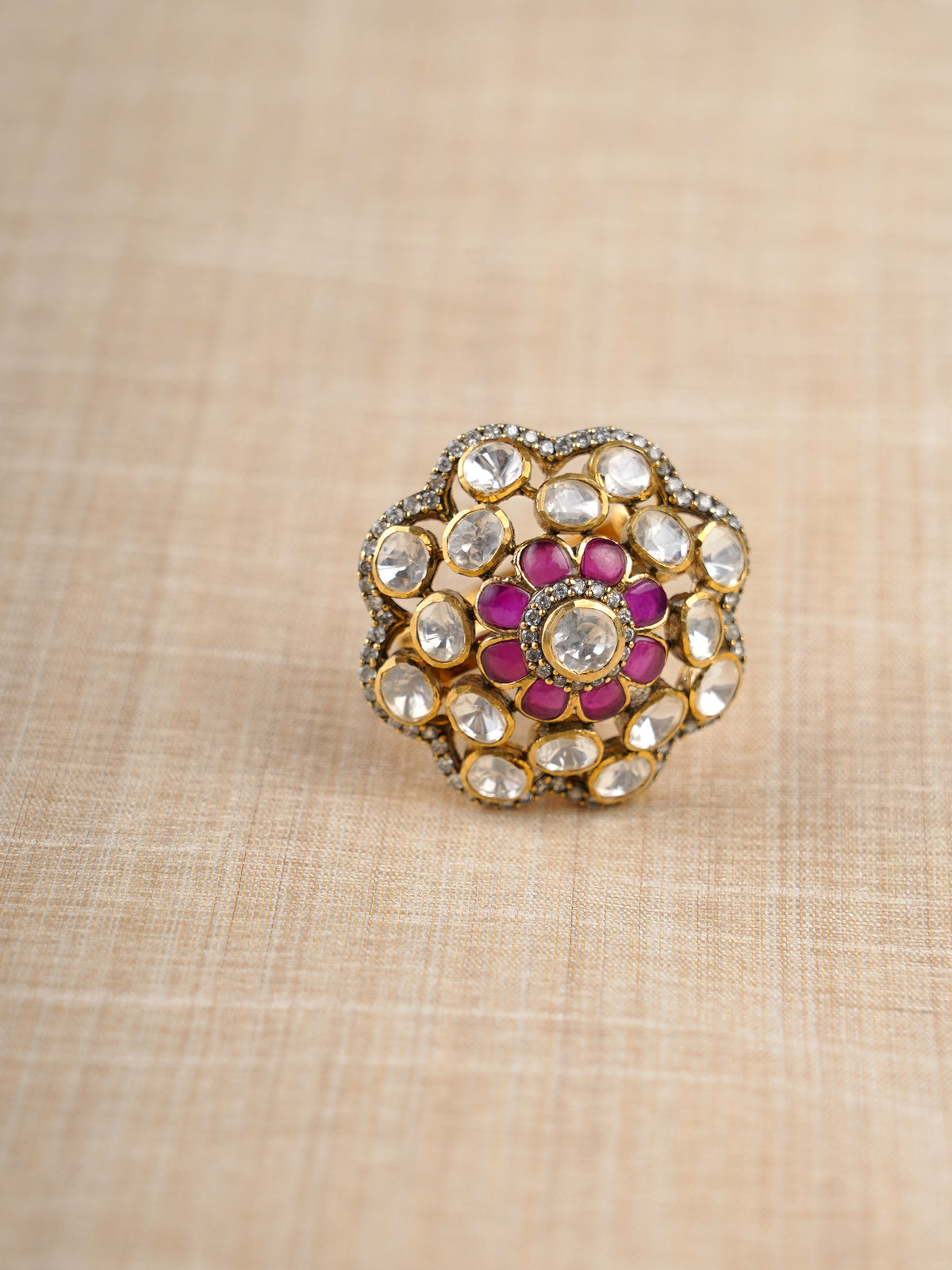 Sitaratna ruby and white floral halo moissanite ring styled on hand