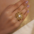 Sitaratna silver moissanite statement ring with gold-tone floral leaf design, white centre stone and seed-pearl halo