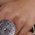 Sitavan large round oxidised silver statement ring with engraved floral chakra pattern and textured beaded border